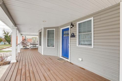 a front porch of a house with a blue door at Long Branch Getaway - Walk to Beaches and Dining! in Long Branch
