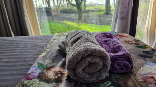 a towel laying on a bed next to a window at City Farmer-Amsterdam, Stay, Inn, Loft, Bed, Bike and Breakfast in Amsterdam