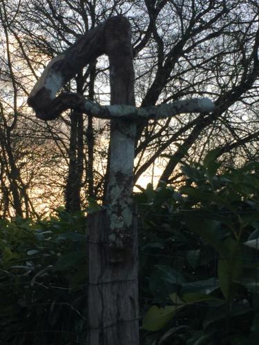 a statue of a horse on top of a cross at St Pasha in Paillé