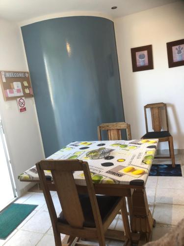 a table and chairs in a room with a table and a table and chairs at St Pasha in Paillé