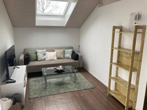 a living room with a couch and a shelf at Wohnresidenz Casa Fortuna in Suhr