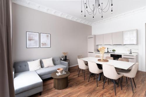 a living room with a couch and a table and chairs at Leipzig Residenz City-Center Apartments in Leipzig