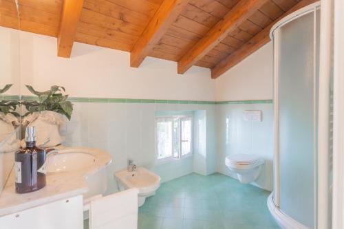 a bathroom with a sink and a toilet at Giuliano's House - Amazing Lake View by Rent All Como in Laglio