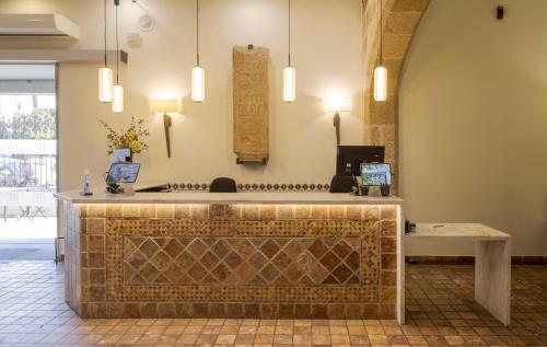 a lobby of a mosque with a tile counter at Hotel Ilunion Mérida Palace in Merida