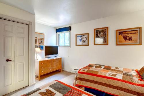 a bedroom with a bed and a television on a dresser at The Forest Neighborhood by Keystone Resort in Keystone
