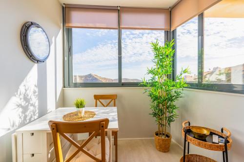 a dining room with a table and chairs and a window at EnviaStudio R&R in La Envia