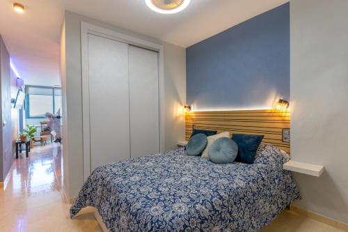 a bedroom with a bed with blue pillows at EnviaStudio R&R in La Envia