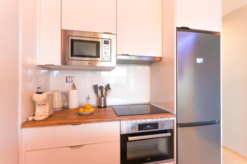 a kitchen with a stove and a microwave at EnviaStudio R&R in La Envia