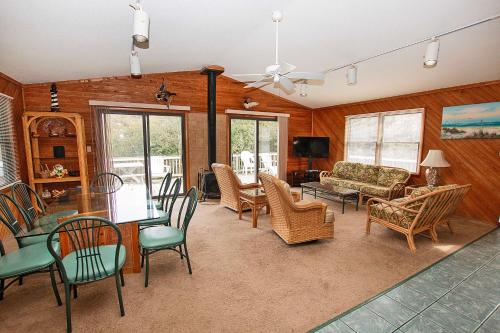 a living room with a table and chairs at Oceanside, Hot Tub, Rec Room, OD1, The Sandy Dune in Duck