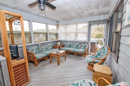 a screened in porch with couches and a tv at Oceanside, Hot Tub, Rec Room, OD1, The Sandy Dune in Duck
