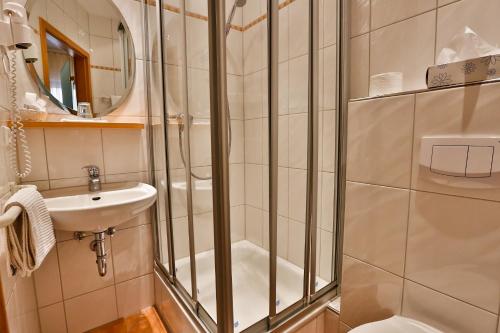 a bathroom with a shower and a sink at Hotel Ochsen in Ammerbuch