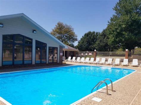 a large swimming pool with chairs and a building at FREE Silver Dollar City & other ATTRACTION TICKETS! Spacious, Great location, Indoor & Outdoor pools in Branson