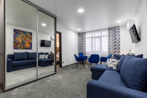 a living room with a blue couch and a mirror at SPA Hotel Galera in Kyiv