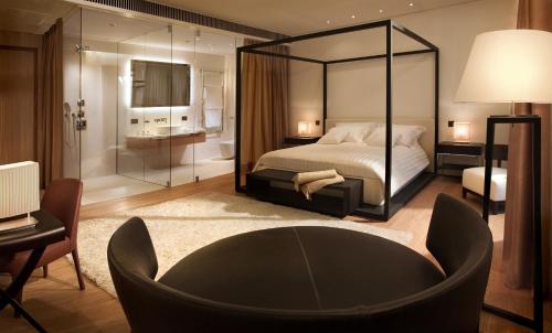a bedroom with a bed with a large mirror at Principe Forte Dei Marmi - Resort & Spa in Forte dei Marmi