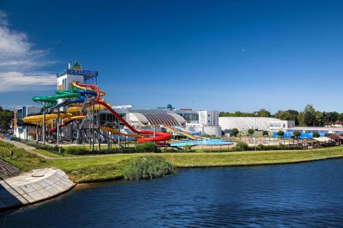 a water park with a water slide next to a river at Apartment near Baltic Sea in Jūrmala