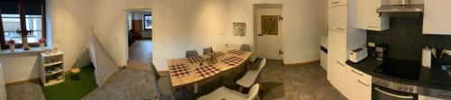 a kitchen with a table in the middle of a room at Hotel zum Urviech -Erwachsenenhotel- in Ehrwald