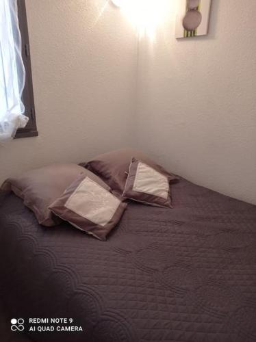 - un lit avec 3 oreillers dans l'établissement Rez de jardin Pinède Proximité Quartier Naturiste, au Cap d'Agde