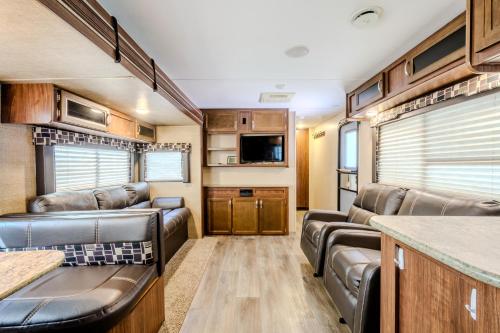 a living room with leather furniture in a rv at West Coast Inn's in Rincon