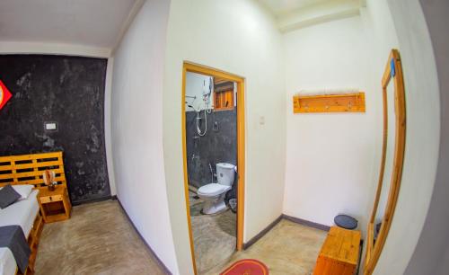 a small bathroom with a toilet and a sink at Inside Out Nature Villa in Kandy