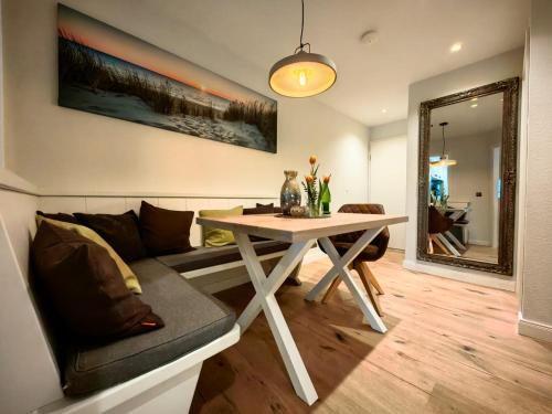 a living room with a table and a couch at nord-ostseeglück in Ladelund