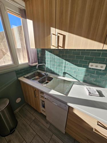 a kitchen with a sink and a counter top at Le Richelieu - calme - central in Pau