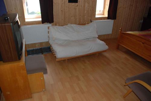 a living room with a couch and a tv at Holiday home in Haj pod Klinovcem 1681 in Háj