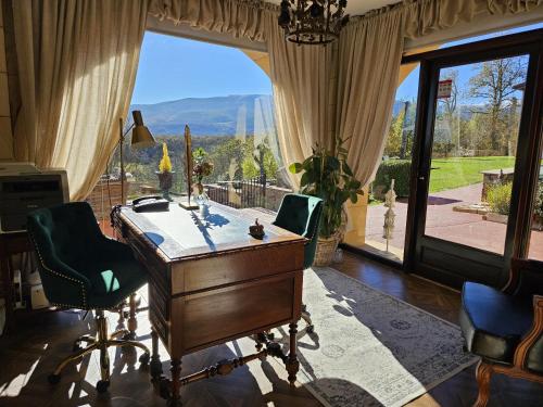 an office with a desk and a large window at Villa Liguardi in Proaño