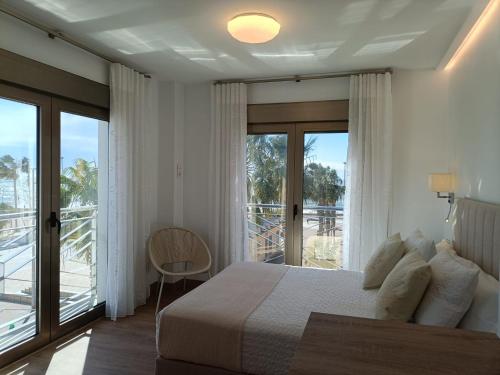 a bedroom with a bed and a balcony at APARTAMENTOS SAN NICOLAS in Adra