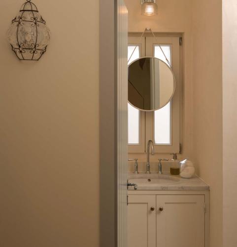 a bathroom with a sink and a mirror at Aghioti in Agios Nikitas
