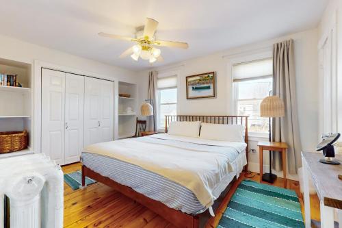 a bedroom with a bed and a ceiling fan at Gloucester Coastal Gem in Gloucester