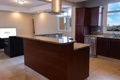 a large kitchen with a large island in the middle at Ciqala Suites Hotel - San Juan in San Juan