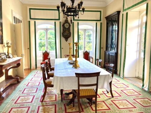 a dining room with a table and chairs at Quinta das Palmeiras in Angra do Heroísmo