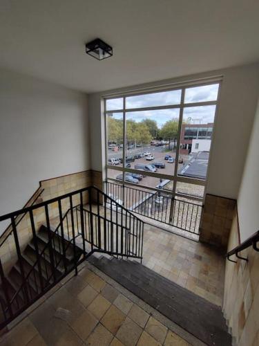 a staircase in a building with a view of a street at Eindhoven City Apartments C 4P Free public parking in Eindhoven