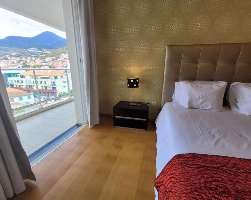 Ένα ή περισσότερα κρεβάτια σε δωμάτιο στο Nova Madeira Apartment Machico