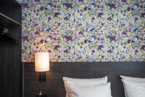 a bedroom with a bed with a large painting on the wall at Thon Hotel Tromsø in Tromsø