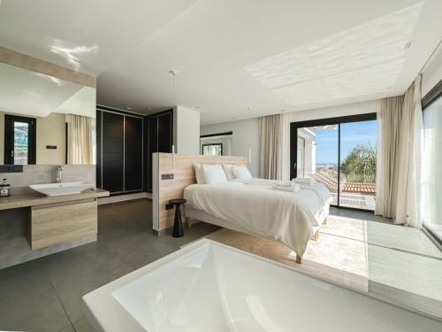 1 dormitorio con cama, lavabo y bañera en Villa Paraiso w parking gym pool lounge cinema, en Estepona