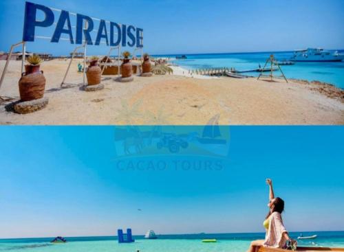 a woman sitting on a beach next to the ocean at Paradise island in Hurghada