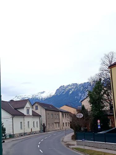an empty street in a town with mountains in the background at Apartments Romantic and Family Room Zemlinski in Payerbach