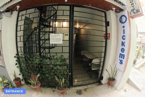 an entrance to a building with a gate and plants at Dickem's Transient House in Cebu City