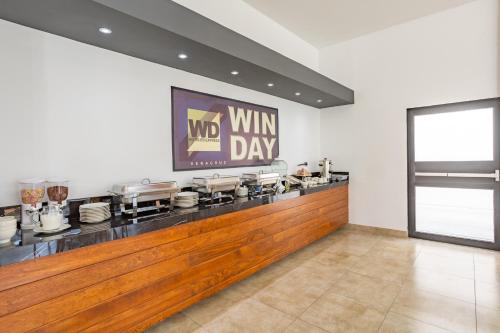 a restaurant with a wine day sign on the wall at WinDay Hotel Express in Veracruz