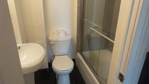 uma casa de banho com um WC, um lavatório e um chuveiro em Midtown Nest Studio Self Serviced Apartment Sleeps 5 em Nova York