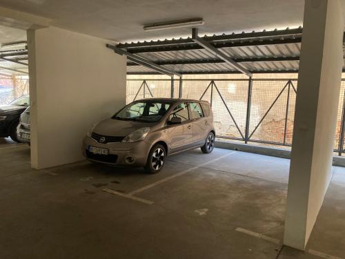 a small car parked in a parking garage at Apartmani Simić Quatro in Valjevo