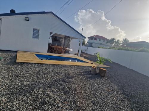 a house with a swimming pool in front of it at Au Petit Paradis in Saint-François