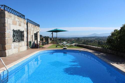 a swimming pool with a view of the mountains at Paço AL in Monção