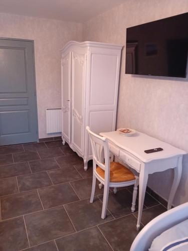 a white table and a white cabinet in a room at la pêcherie bord de mer in La Plaine-sur-Mer
