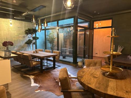a dining room with a wooden table and chairs at Hannover - PHIL & MAX Hotels und Apartments Messe in Hannover