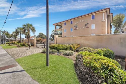 a building with a sign on the side of it at 3 BR Condo 2 Pools and Hot Tub Walk to Beach in Tybee Island