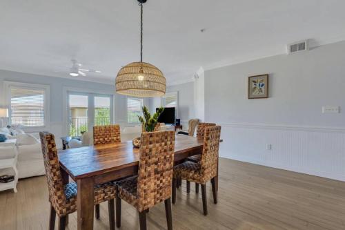a dining room and living room with a table and chairs at 3 BR Condo 2 Pools and Hot Tub Walk to Beach in Tybee Island