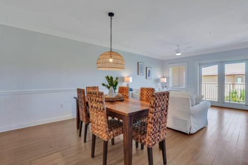 a dining room and living room with a table and chairs at 3 BR Condo 2 Pools and Hot Tub Walk to Beach in Tybee Island