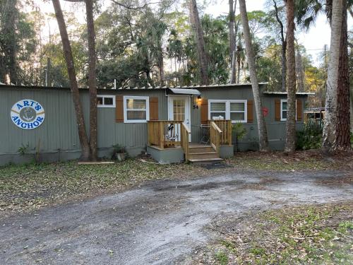 a tiny house in the woods with a driveway at Nature Coast Inn & Cottages in Inglis